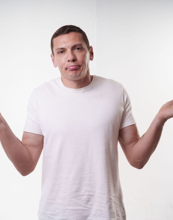 A man shrugging with both palms up