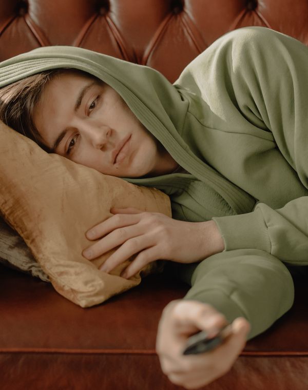 A man lying on a pillow staring blankly